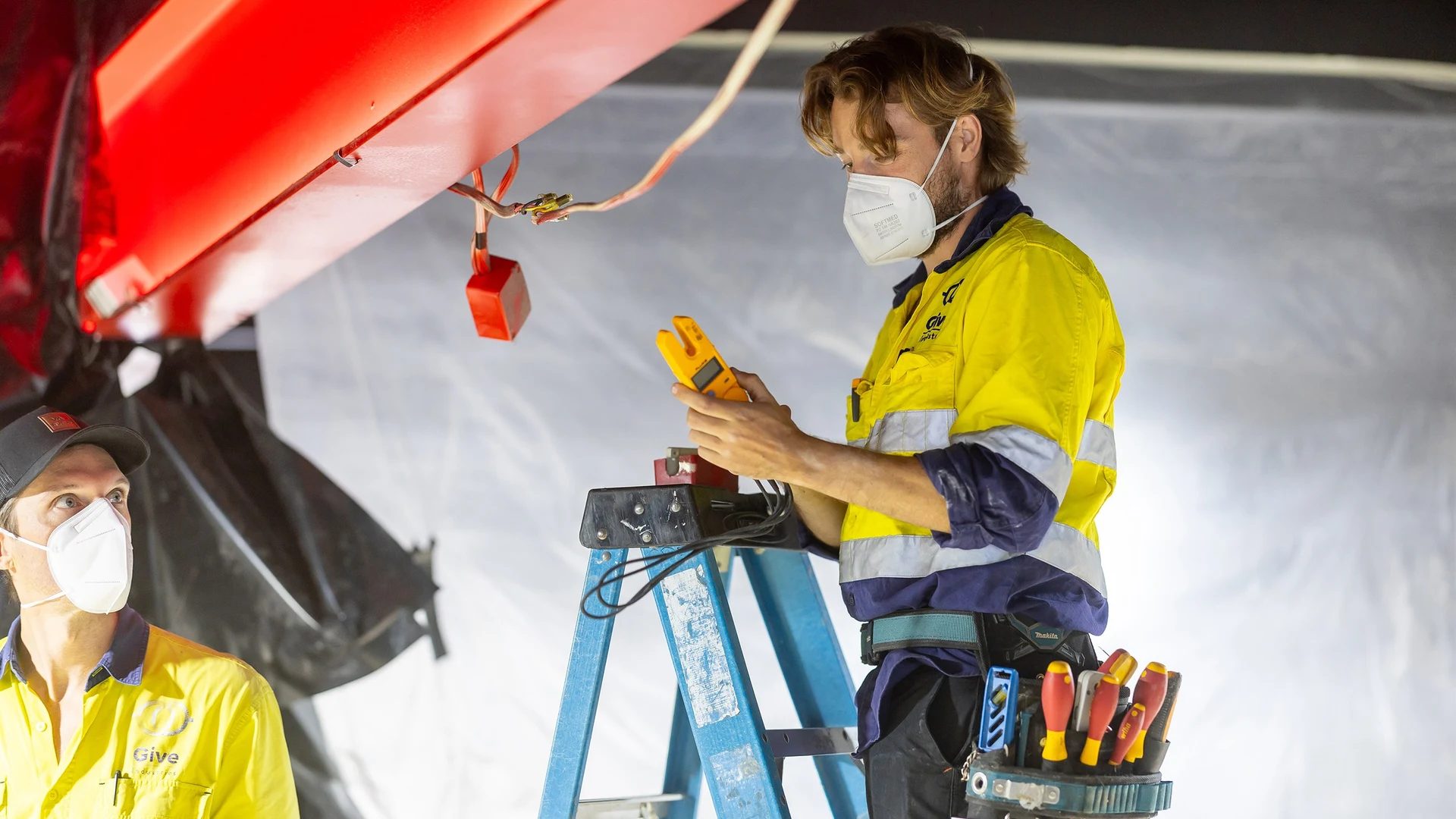 Give Industries electricians working from an elevated platform on a construction project