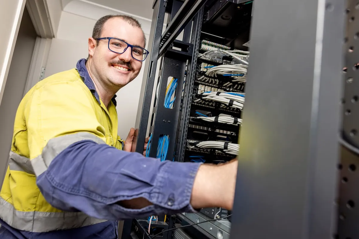 Give Industries team members smiling in high visibility workwear