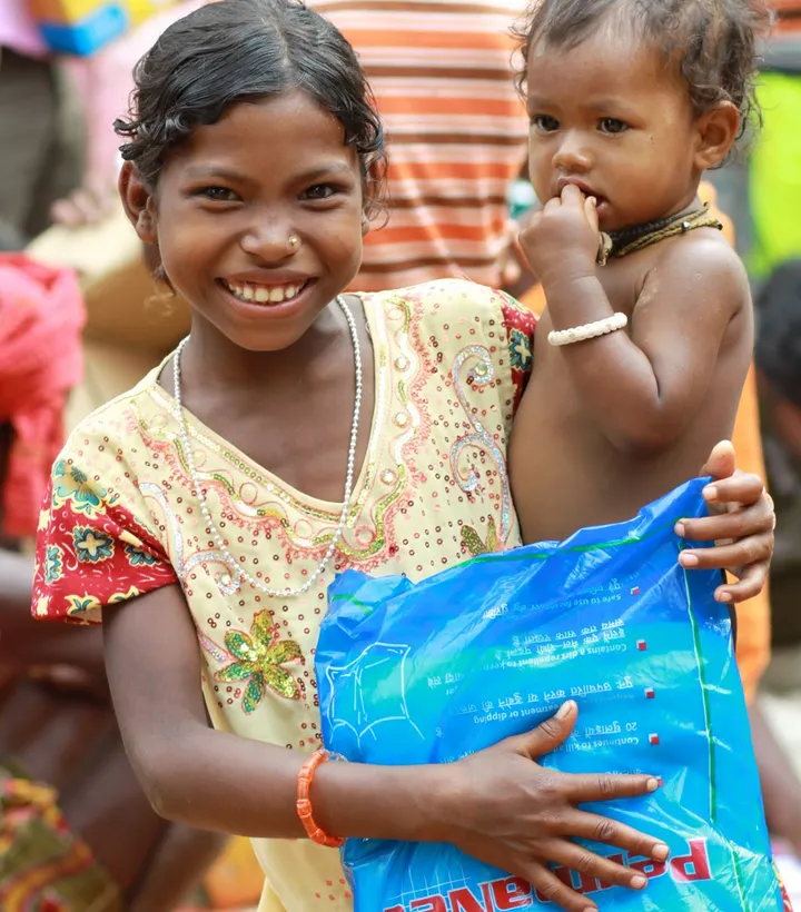 Child looking toward the camera during charity-supported community work in India