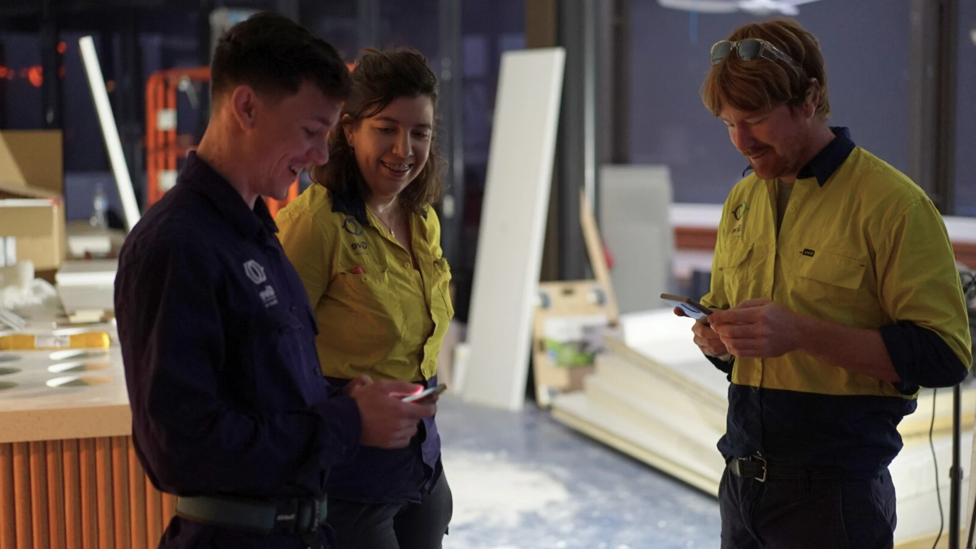 Give Industries electrician reviewing plans on site